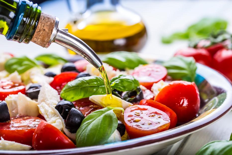 Caprese-Salat mit Olivenöl ist ein mediterranes Essen. Man sollte nur gutes Olivenöl verwenden