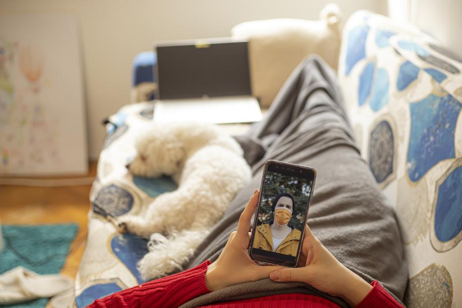 Young woman talking with her boyfriend over mobile phone video call stock photo