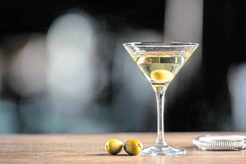 Dry Martini short drink cocktail with gin, dry vermouth and an olive garnish.