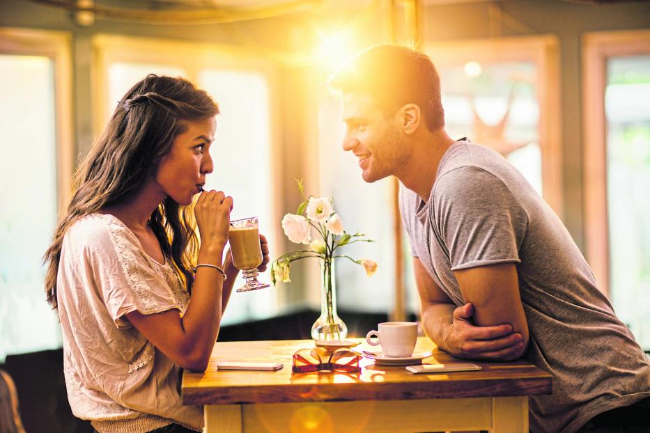 Young couple in love spending time together in a cafe.