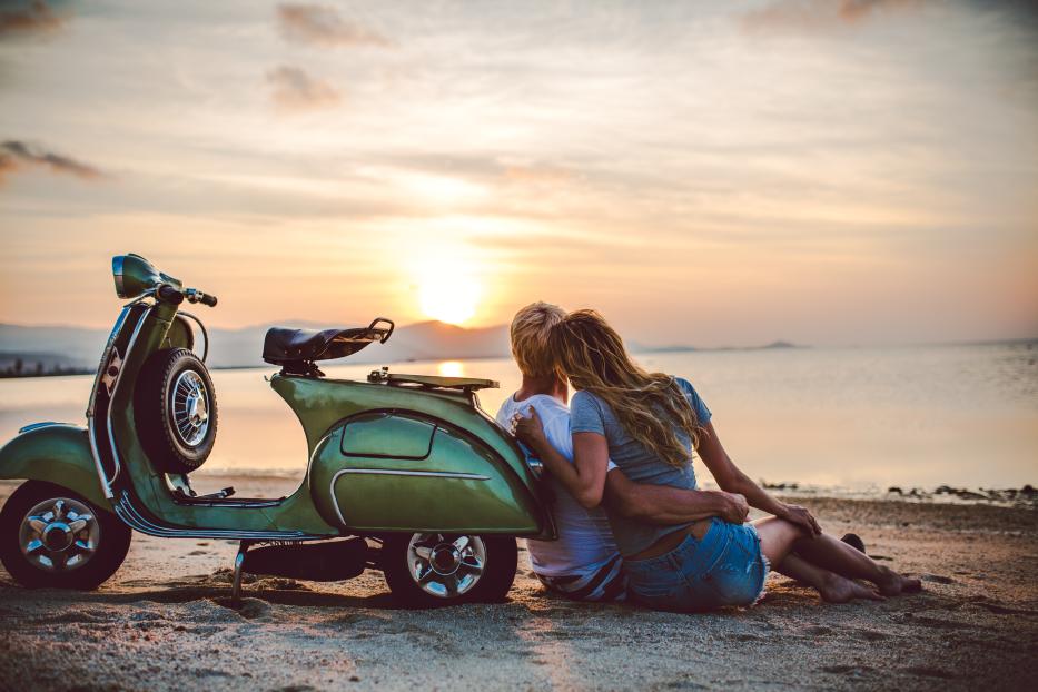 Couple on the beach with retro bike