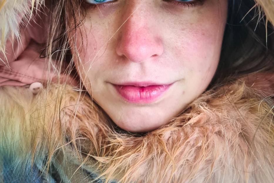 Close-Up Portrait Of Young And Beautiful Woman With Blue Eyes 