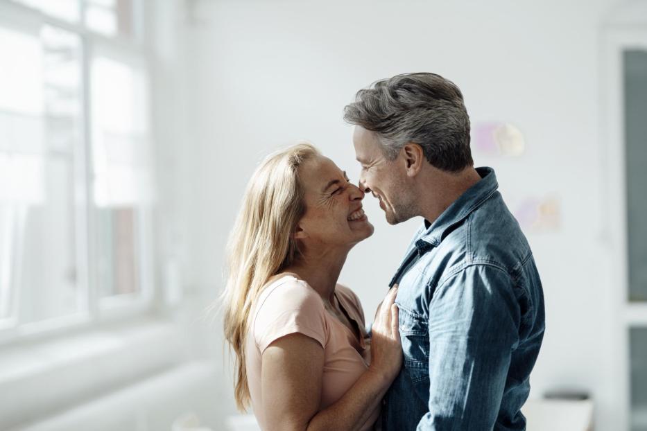 Affectionate couple touching noses at home - Stock-Fotografie