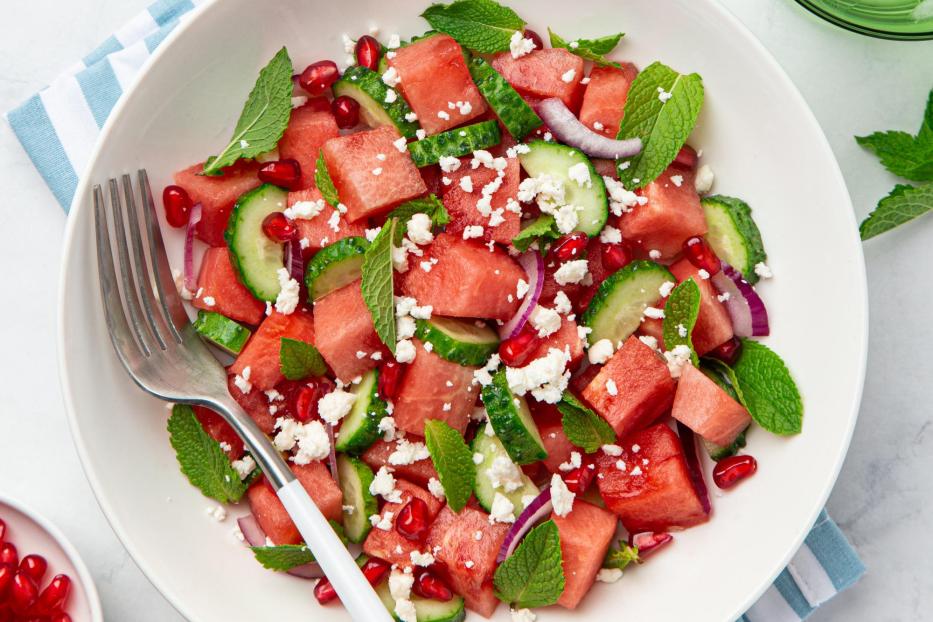 Watermelon, cucumber, feta and mint salad in white bowl