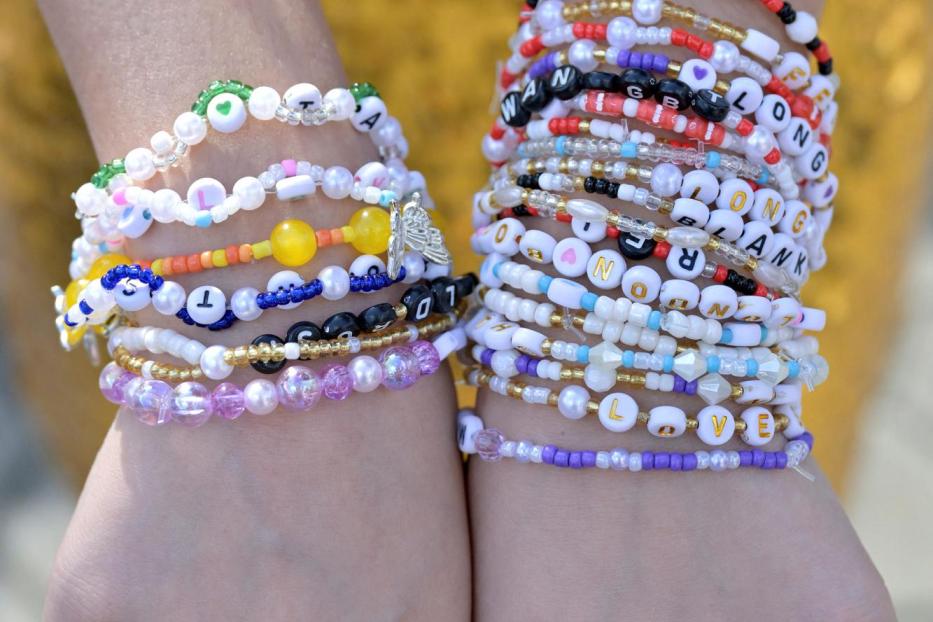 Taylor Swift's fan, Heart Ballado, 28, from Cebu City in Philippines poses with her friendship bracelets at the National Stadium on the first night of Taylor Swift's Eras Tour concert in Singapore