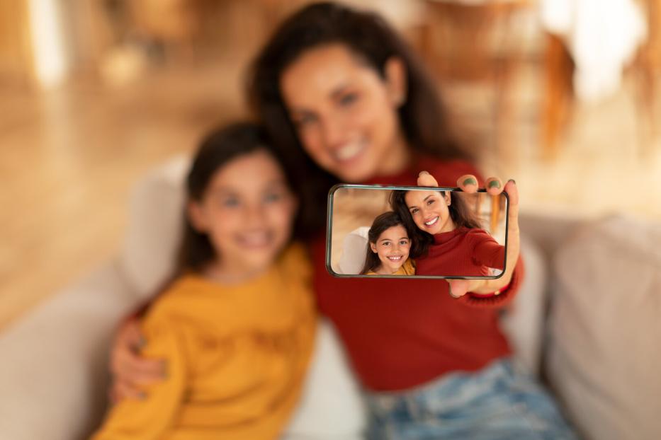 Middle Eastern Mom And Daughter Making Selfie Via Phone Indoor