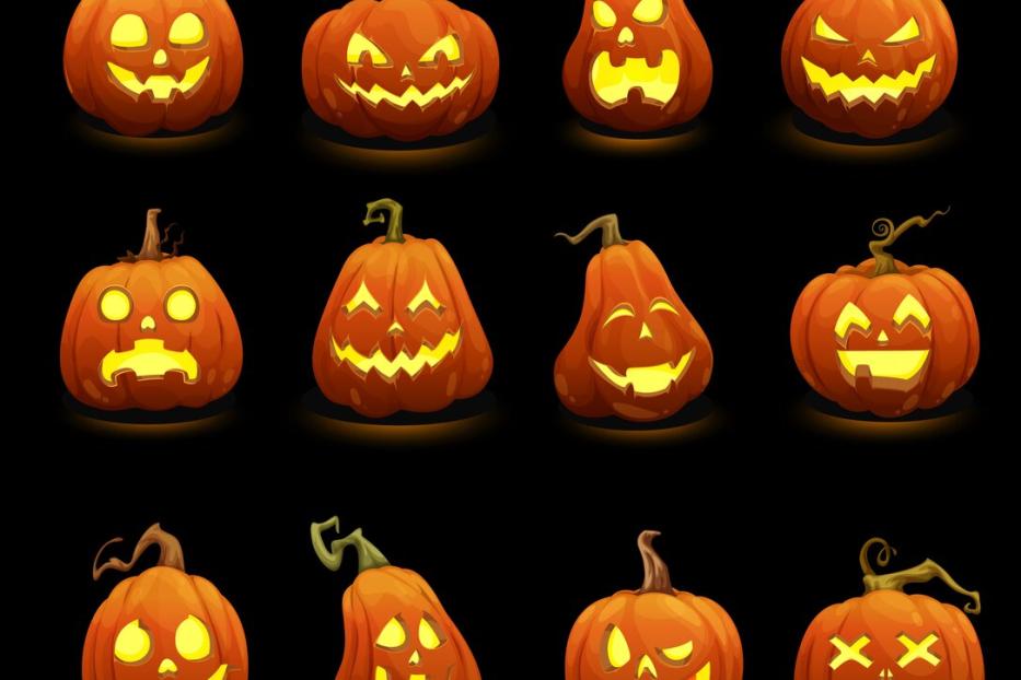 Halloween pumpkins faces glowing in darkness