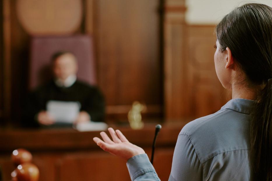 Young Adult Asian Woman Testifying in Courtroom during Legal Proceedings