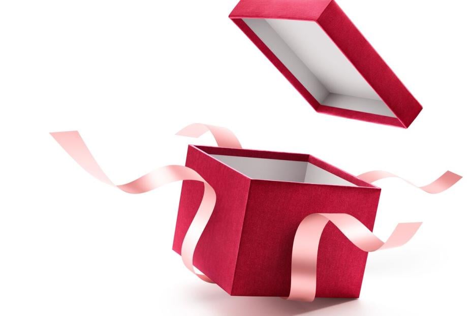 Eine offene, rote Geschenkbox mit rosa Schleifen schwebt vor einem weißen Hintergrund.