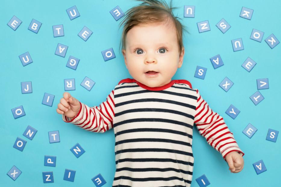 Portrait of adorable 3 months old baby on the blue background, studio shot
