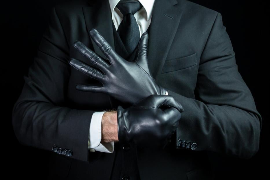 Mafia Hit Man Pulling on Leather Gloves