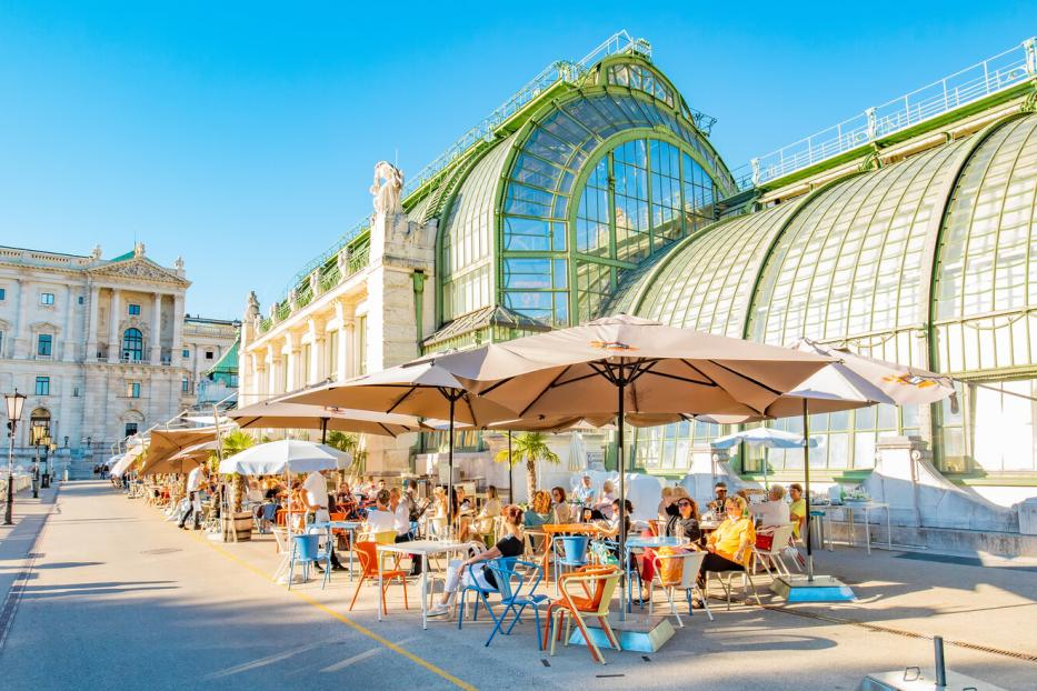 Summer street cafe in Vienna old town, Butterfly House (Schmetterlinghaus) on background