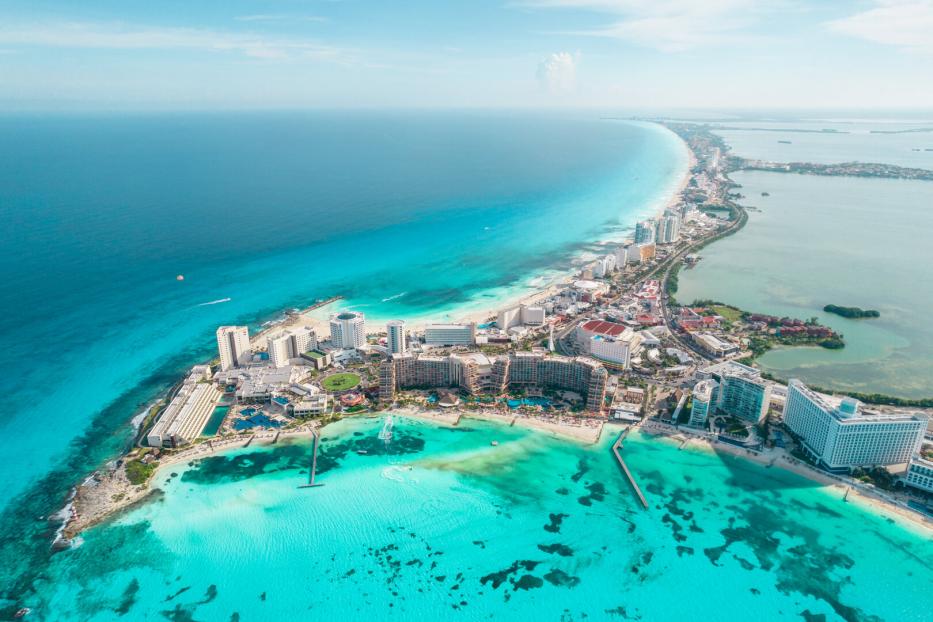Aerial panoramic view of Cancun beach and city hotel zone in Mexico. Caribbean coast landscape of Mexican resort with beach Playa Caracol and Kukulcan road. Riviera Maya in Quintana roo region on Yucatan Peninsula
