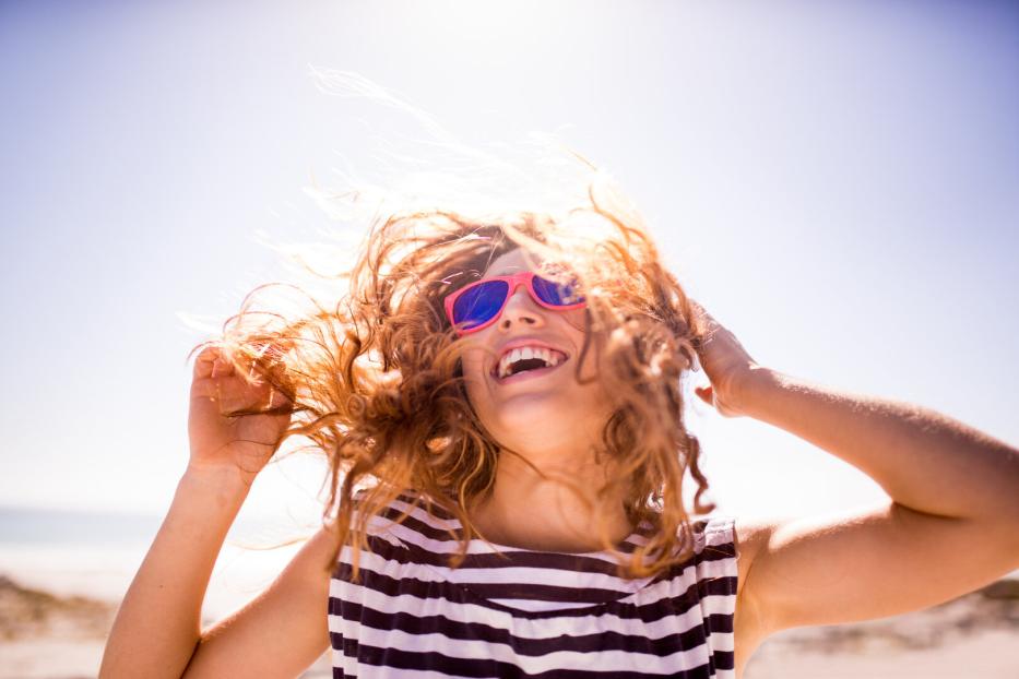 Cheerful laughing woman on the beach