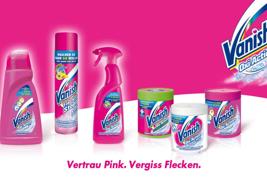 Verschiedene Vanish-Produkte zur Fleckenentfernung vor einem pinkfarbenen Hintergrund.