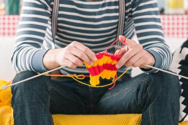 Young man knitting