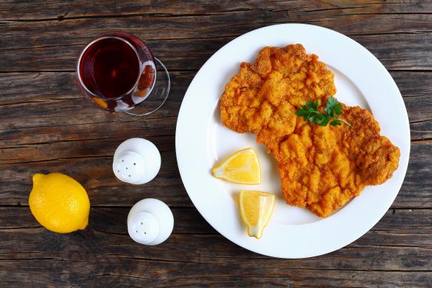 Wiener schnitzel with glass of red wine