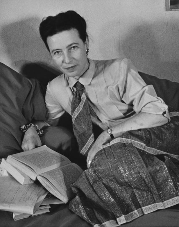 Portrait of French writer and philosopher Simone de Beauvoir (1908 - 1986) as she reclines on a couch, Paris, France, 1952. (Photo by Gisele Freund/Photo Researchers History/Getty Images)