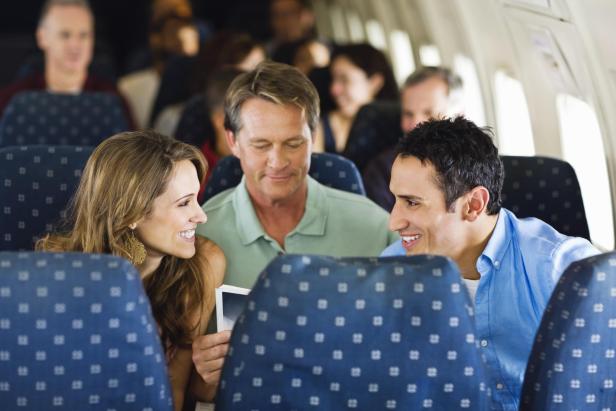 Man and woman talking on an airplane - Stock-Fotografie