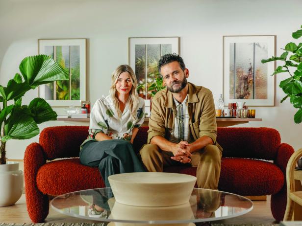 Miriam und Christian Cervantes die Inhaber auf einem roten Sofa in ihrem neu gestalteten Concept-Store Calienna in Wien Neubau, im Hintergrund stehen Pflanzen auch der Couchtisch wurde von Cervantes designt