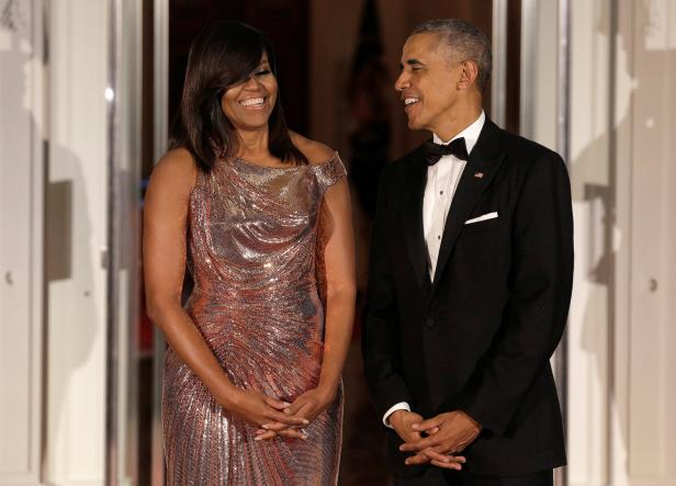 U.S. President Barack Obama and U.S. first lady Michelle Obama speak before the arrival of Italian Prime Minister Matteo Renzi and his wife Agnese Landini at the White House in Washington.
