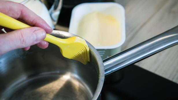 Schritt 1: Den oberen Rand des Kochtopfes mit Butter einstreichen