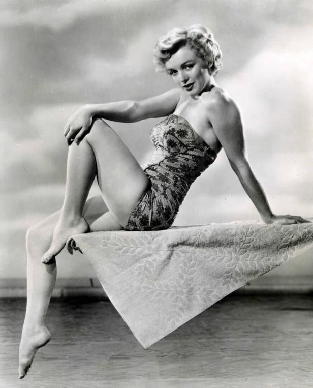 American actress Marilyn Monroe posing sitting on the trampoline in a swimsuit 02738 American actress Marilyn Monroe posing sitting on the trampoline in a swimsuit 02738