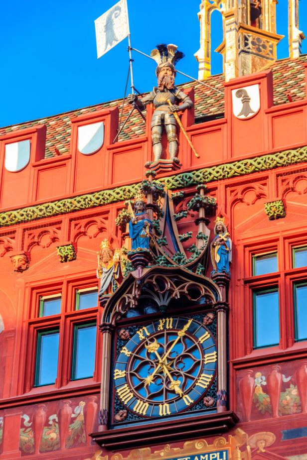 Basler Rathaus Close-up of red town hall with clock, paintings and ornaments in Basel, Switzerland