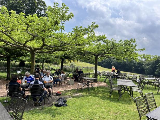 Gäste sitzen im Gartenrestaurant Alpe Vicania in Lugano.