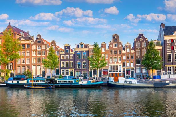 Amsterdam Amsterdam. Panoramic view of the historic city center of Amsterdam. Traditional houses and bridges of Amsterdam. An early quiet morning. Europe, Netherlands, Holland, Amsterdam.