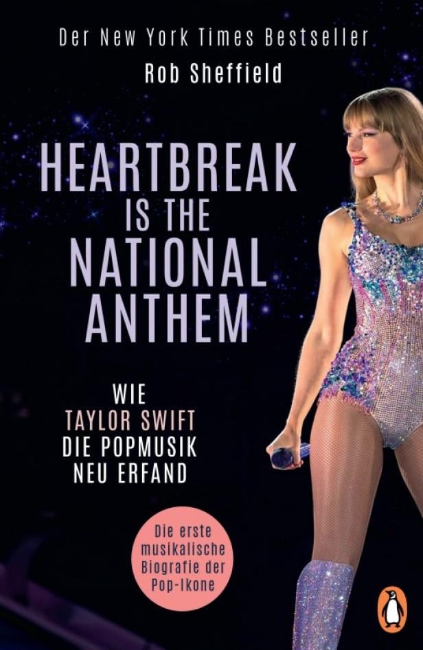 Buchcover von "Heartbreak is the National Anthem" - darauf ist Taylor Swift zu sehen, wie sie im Glitzer-Body auf der Bühne steht.