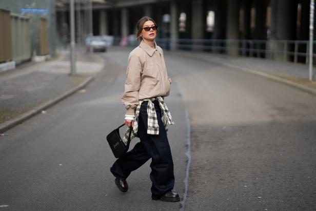 Influencerin Sophia Geiß geht über eine Straße in Berlin - um ihre Hüfte ist ein Karohemd gebunden