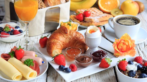 rich breakfast on wooden table