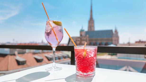 Two glasses of cocktails on a table in bar terrace with observation deck
