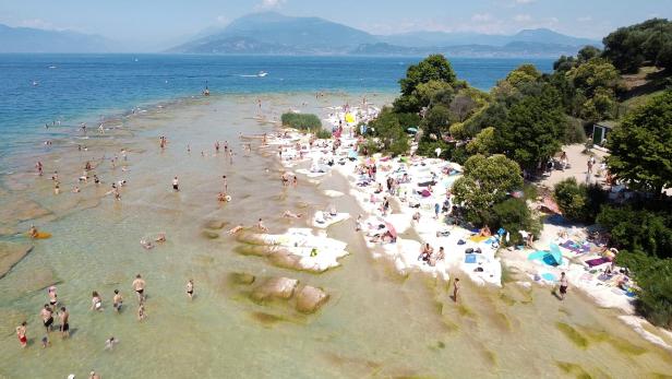 People flock to one of the beaches of Lake Garda, in southern Sirmione Peninsula