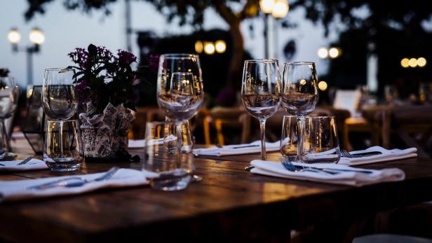 Luxury table settings for fine dining with and glassware, beautiful blurred  background. For events, weddings.