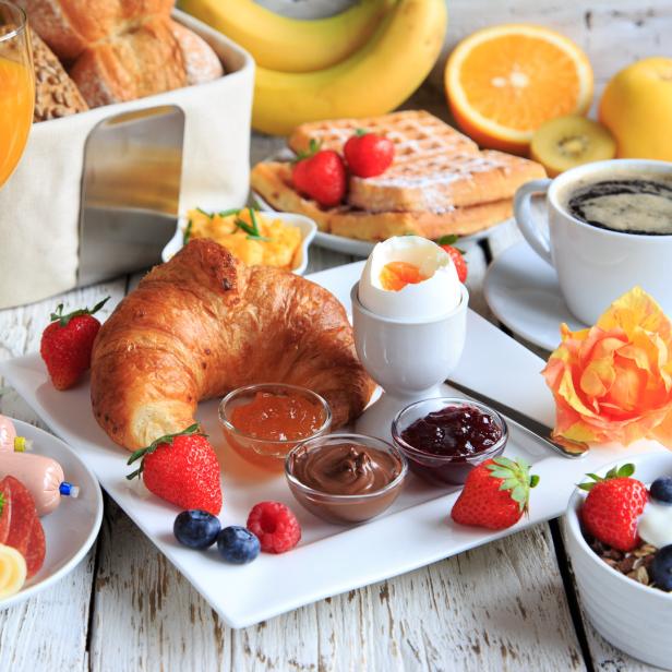 rich breakfast on wooden table