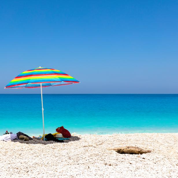 Blue sea, white beach and colorful umbrella