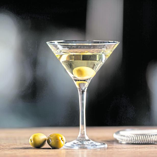 Dry Martini short drink cocktail with gin, dry vermouth and an olive garnish.