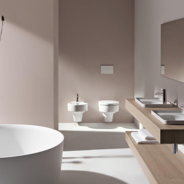 Ein modernes Badezimmer mit Badewanne, Bidet, Toilette und Doppelwaschbecken.