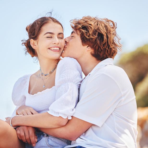 Shot of a young couple spending time together at the beach