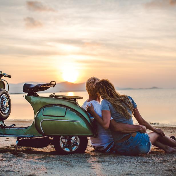 Couple on the beach with retro bike