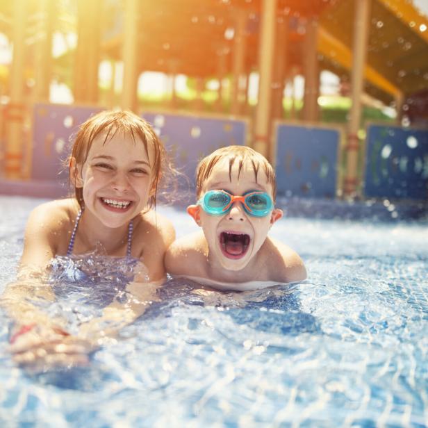 Brother and sister having fun in water park