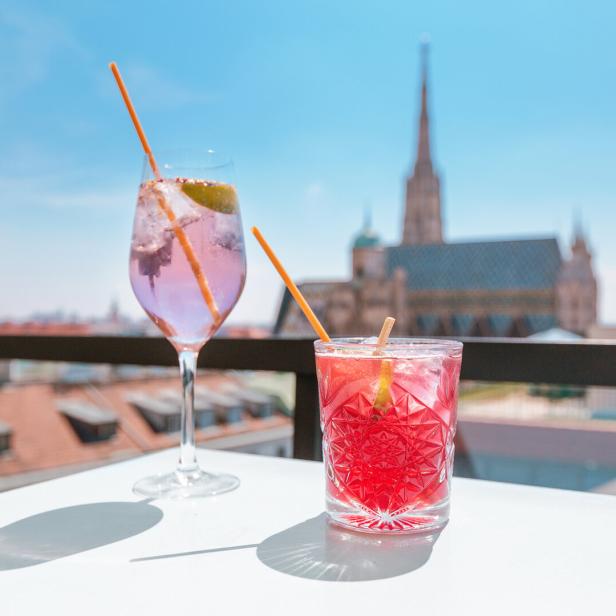 Two glasses of cocktails on a table in bar terrace with observation deck