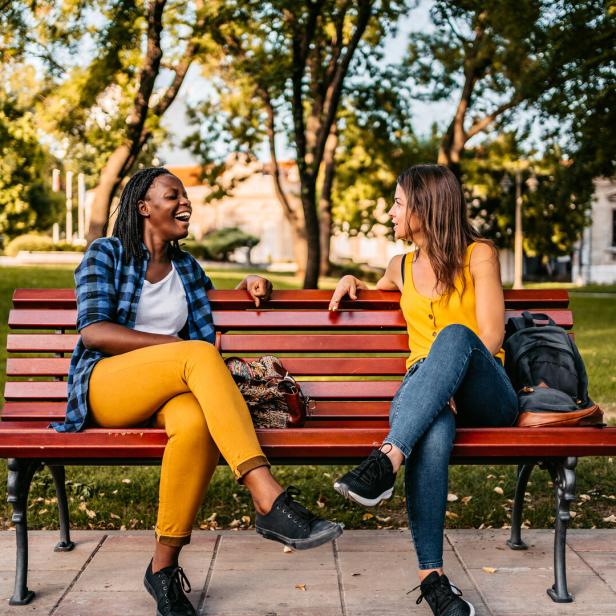 Friends talking on bench
