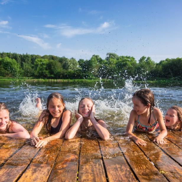 Happy children enjoying summer holidays at a lake Happy children enjoying summer holidays at a lake