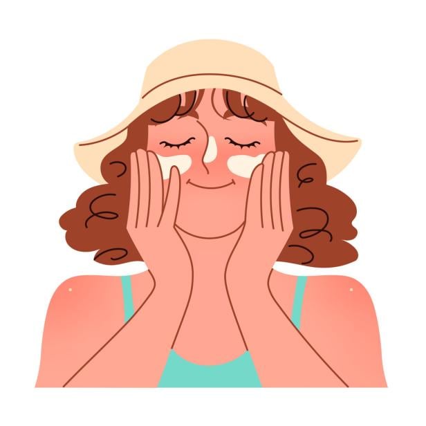 A woman applies sunscreen to her face SPF cream protection A woman applies sunscreen to her face SPF cream protection