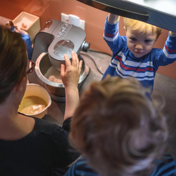 Mother and Sons Baking Cookies in the Morning