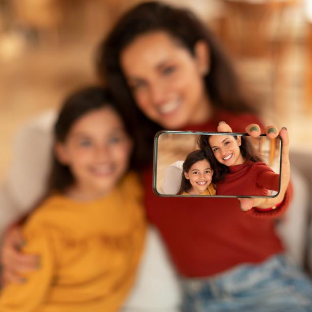 Middle Eastern Mom And Daughter Making Selfie Via Phone Indoor Middle Eastern Mom And Daughter Making Selfie Via Phone Indoor