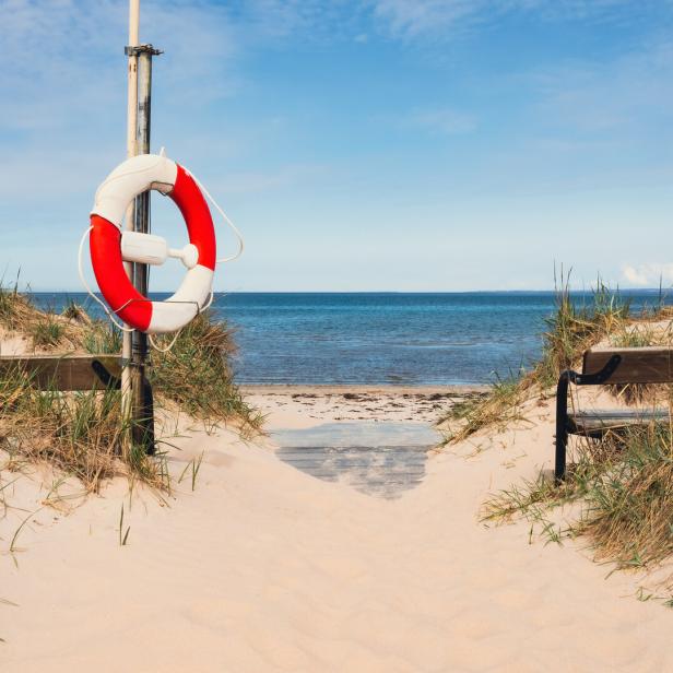 Benches on a beautiful white sand beach in south Sweden. Popular tourist destination.